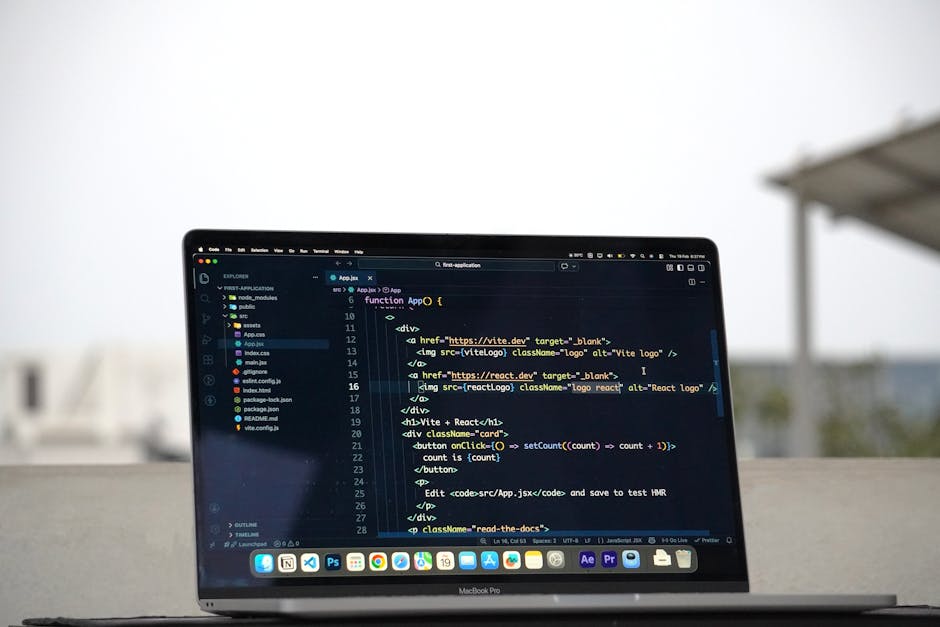 A person wearing a striped shirt is working on a laptop with a dark screen displaying lines of colorful code, placed on a white desk. To the left of the laptop, there is a black ceramic mug. Behind th